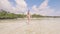 Young woman in bikini walking on sea water at sandy beach on paradise resort. Low angle view. Beautiful woman running on