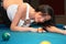 Young woman on the billiard table
