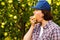 Young woman biting and chewing apple in orchard