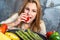 Young Woman Biting a Tomato