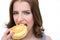 Young woman bitting doughnut