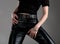 Young woman in black leather pants