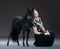 Young woman with black stallion. American Miniature Horse.