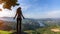 Young woman with blond dreadlocks standing on the edge of a cliff and looks down at on the Douro Valley, Portugal.