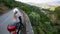 Young woman with blond dreadlocks travels on a motorcycle on the Douro Valley, Portugal.