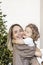 A young woman with blond hair and a little daughter against the backdrop of Christmas decorations. New year concept