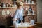 young woman blonde erotic prepares dough in the kitchen. housewife with bags of flour and with rolling pin in the kitchen