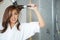 Young woman blow drying hair