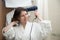 Young woman blowing her hair with hairdryer