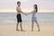 Young woman in this blue bikini hugging her boyfriend happily on the beach in Nai Thon Beach, Phuket, Thailand. Portrait of happy