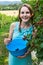Young woman in blue dress picking blackberries