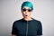 Young woman with blue fashion hair wearing thug life sunglasses over white background afraid and shocked with surprise expression,