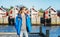 Young woman in a blue jacket on a background of traditional red Norwegian Rorbu houses traveling to Lofoten Norway