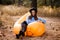 Young woman in blue sweater and black hat admires forest sunset outdoor on inflatable sofa