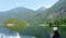 A young woman on a boat admiring the beautiful views of the forested mountains and beautiful calm ocean waters of Princess Louisa