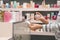 Young woman with bottle of perfume and blotters in shop, closeup