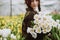 Young woman with a bouquet of spring flowers tulips. Soft selective focus, defocus