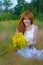 Young woman with bouquet of wild flowers