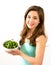 Young woman with bowl of kale