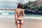 young woman without bra on the tropical beach of Bali island. Bikini girl freedom concept. Indonesia.