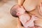 Young woman breastfeeding a baby newborn
