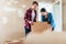 Young woman bringing open box moving in with her boyfriend into