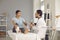 Young woman with broken leg talking to doctor during medical checkup at the hospital