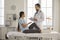 Young woman with broken leg talking to doctor during medical exam at the hospital