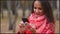 Young woman browsing the Internet on the phone, text messages and chatting outdoors.