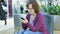 Young woman browsing on smart phone in shopping mall