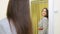 Young woman brunette poses looking at costume in mirror