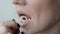 Young woman brushes her teeth with a floss