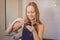 Young woman brushing her teeth with a black tooth paste with active charcoal, and black tooth brush in her bathroom