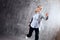 Young woman in business suit and sneakers. runner`s pose, ready to run a long distance.