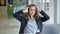 Young woman business worker taking glasses off stretching arms at the office