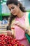 Young woman buying cherries