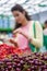 Young woman buying cherries