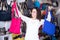 Young woman buying leather purse in haberdashery shop