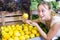 Young woman buying lemons at market