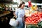 Young woman buying vegetables at the market.