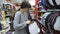 A young woman buys a cover on the steering wheel in the store.