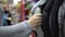 A young woman buys a cover on the steering wheel in the store.