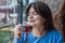 A young woman in a cafe drinks Turkish tea.