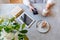 Young woman in a cafe works on smartphone while sitting in a cafe. Blond business woman in white clothes. Flat lay