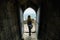 Young woman with a camera in an old abandoned fortress. Travel.