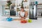 Young woman cancer survivor cooking and preparing vegetarian meal after long heavy sickness. Vegan female in the kitchen making