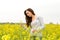 Young woman in canola field