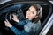 Young woman in car going on road trip.Learner driver student driving car.Driver license exam