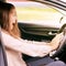 Young woman in car. Ride instruction accident. Automobile loan