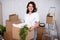 Young woman with cardboard boxes ready to moving day